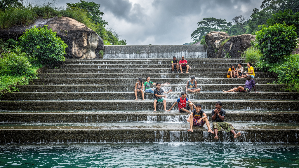 Bushi Dam with water flowing down stone steps during monsoon